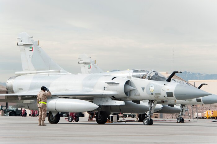 A United Arab Emirates Air Force crew chief salutes a Mirage 2000-9 pilot prior to take-off on the Nellis Air Force Base flight line Jan. 23, 2013. Six UAEAF's Mirage 2000-9 are participating in Red Flag 13-2 exercise. (U.S. Air Force photo by Lawrence Crespo)