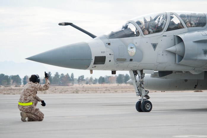 A United Arab Emirates Air Force crew chief performs a pre-flight inspection on the brakes of a Mirage 2000-9 prior to a Red Flag 13-2 mission on the Nellis Air Force Base flight line Jan. 23, 2013. The U.S. Air Force is hosting approximately 170 UAEAF pilots, maintainers and support personnel at the world's premier large force employment and integration Red Flag exercise. (U.S. Air Force photo by Lawrence Crespo)
