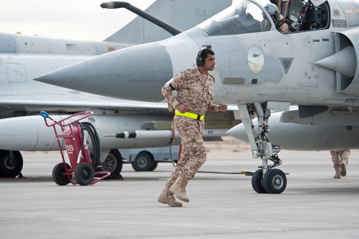 A United Arab Emirates Air Force crew chief performs a pre-flight inspection on a Mirage 2000-9 prior to a Red Flag 13-2 mission on the Nellis Air Force Base flight line Jan. 23, 2013. The Red Flag exercise provides allied air forces personnel an opportunity to train in a joint combat environment. (U.S. Air Force photo by Lawrence Crespo)