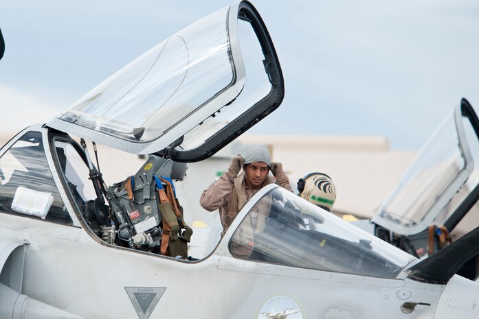 A United Arab Emirates Air Force pilot adjusts his head gear prior to entering a Mirage 2000-9 aircraft during Red Flag 13-2, on the Nellis Air Force Base flight line Jan. 23, 2013. Red Flag is a realistic combat training exercise involving the air forces of the United States and its allies. (U.S. Air Force photo by Lawrence Crespo)