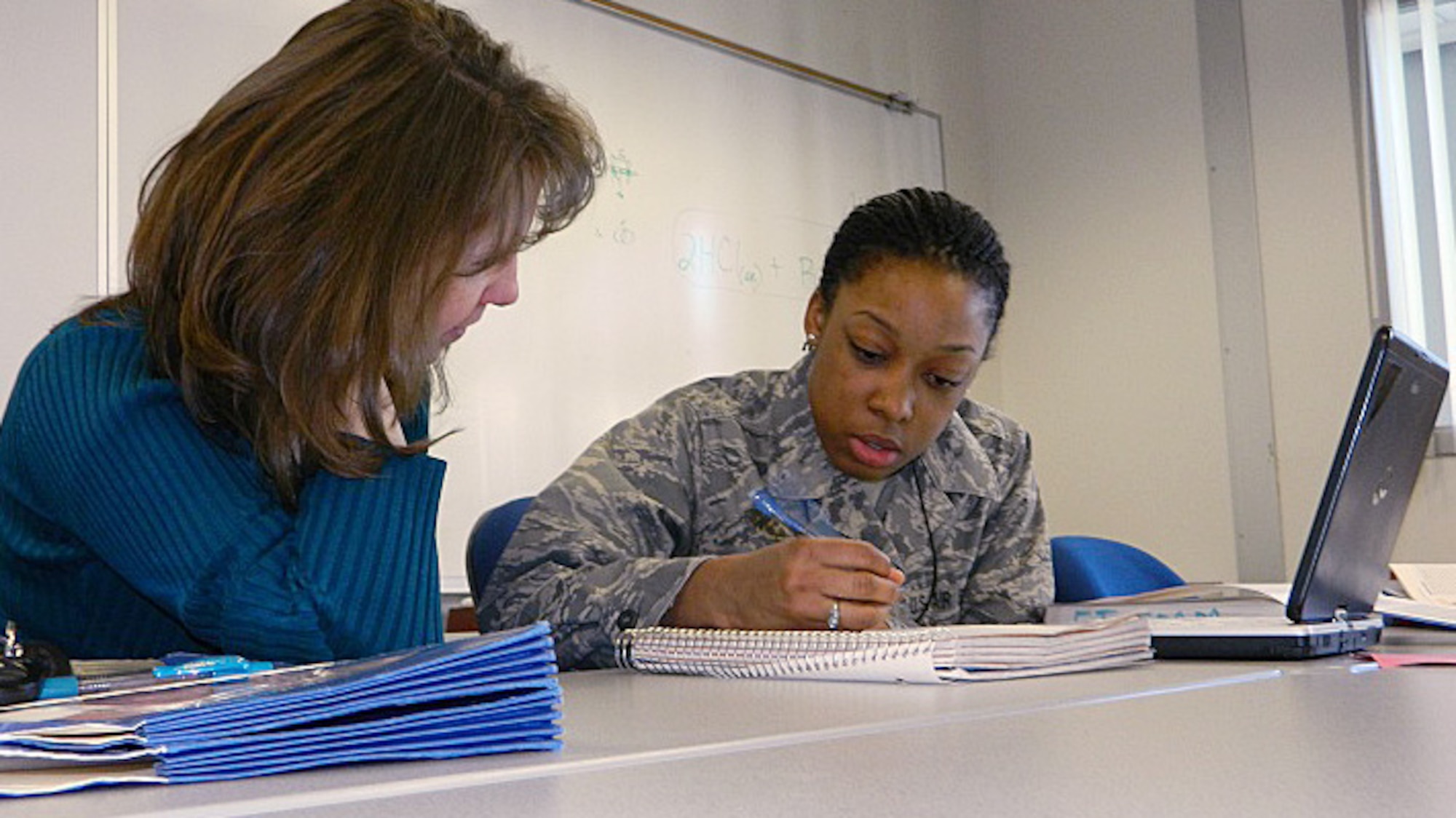Kim Gardner (left) helps Cadet 4th Class Emonna Knox with her chemistry homework Tuesday in the Extra Instruction classroom in Fairchild Annex at the Air Force Academy Jan. 21, 2013. Gardner is an associate professor in the Academy's Chemistry Department. (U.S. Air Force photo/Amber Baillie)