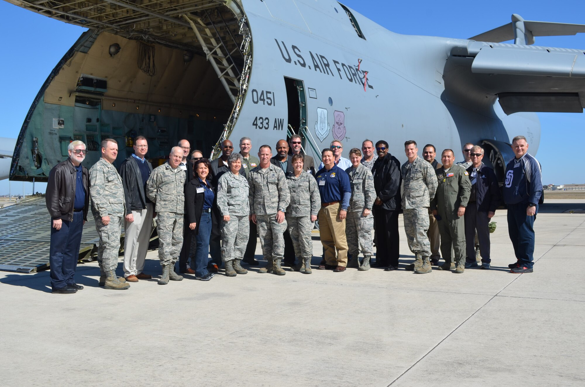 Fifteen Honorary Commanders assigned to the 433rd Airlift Wing pose with their partnered wing senior leadership and delegates in front of a massive C-5A Galaxy assigned to the "Alamo Wing" at the end of their tour of the mainteance group, Jan. 18, 2013.  The Honorary Commander program joins area civic and business leaders with wing senior leadership to learn about the wing's mission and its role in the Air Force Reserve and the national defense.(U.S. Air Force Photo/Major Timothy Wade) 