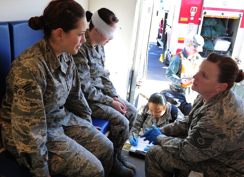 Simulated injured personnel talk to an emergency medical responder during an exercise at Cannon Air Force Base, N.M., Jan. 24, 2013. Base emergency responders participate frequently in exercises in order to prepare themselves for real world events. (U.S. Air Force photo/Airman 1st Class Ericka Engblom)
