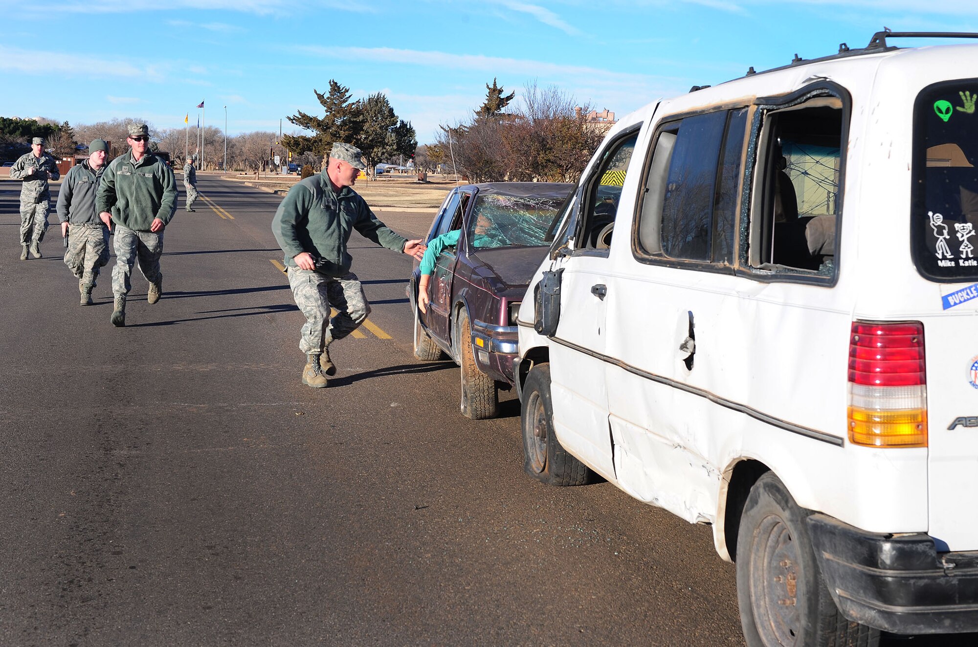 Participants in an exercise rush to the scene of a simulated accident at Cannon Air Force Base, N.M., Jan. 24, 2013. Base emergency responders participate frequently in exercises in order to prepare themselves for real world events. (U.S. Air Force photo/Airman 1st Class Ericka Engblom)