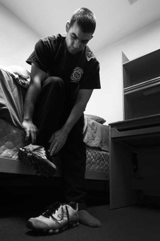 U.S. Air Force Staff Sgt. Derek Dobbins, 633rd Civil Engineer Squadron fire department crew chief, trains to respond to a late-night emergency at the fire department on Langley Air Force Base, Va., Jan. 15, 2013. Personnel at Langley’s fire department have 60 seconds to board an alert vehicle, and five minutes to respond on-scene to an incident after receiving an alarm. (U.S. Air Force photo by Staff Sgt. Jeff Nevison/Released)