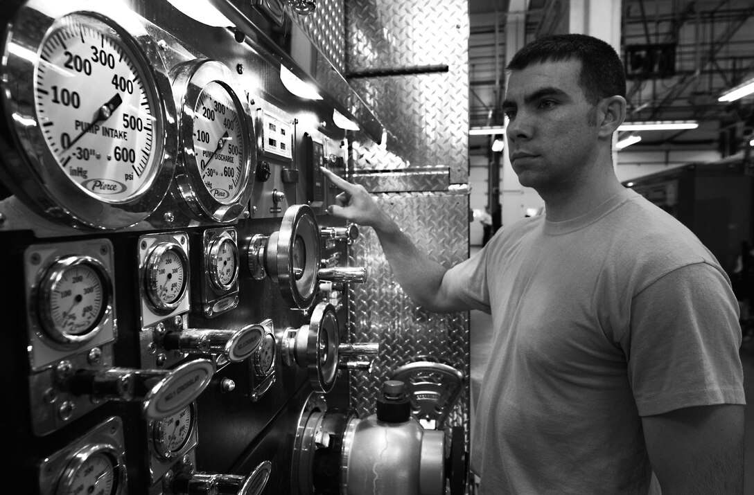 U.S. Air Force Staff Sgt. Derek Dobbins, 633rd Civil Engineer Squadron Fire Department crew chief, checks the gauges on an alert vehicle inside the fire department on Langley Air Force Base Va., Jan. 15, 2013. These levels must be monitored daily to ensure vehicles are equipped and ready to respond to an emergency. (U.S. Air Force photo by Staff Sgt. Jeff Nevison/Released)