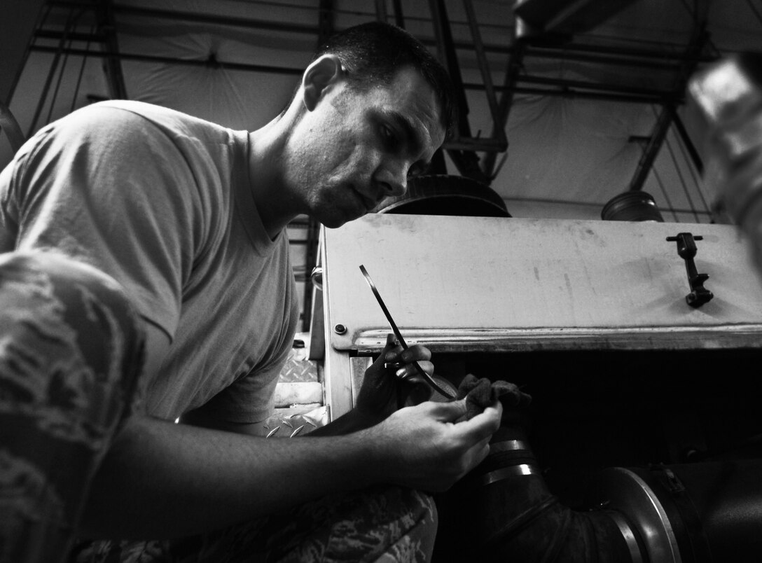 U.S. Air Force Staff Sgt. Derek Dobbins, 633rd Civil Engineer Squadron fire department crew chief, checks oil levels on an alert vehicle inside the fire department on Langley Air Force Base, Va., Jan. 15, 2013.  The fire fighters monitor and maintain their vehicles daily to ensure vehicles are equipped and ready to respond to an emergency. (U.S. Air Force photo by Staff Sgt. Jeff Nevison/Released)