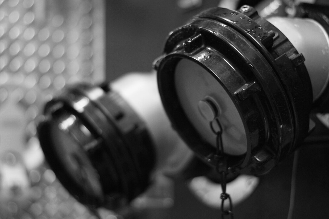 High-pressure water hose connections, like those found on alert vehicles at the fire department on Langley Air Force Base, Va., must be checked and maintained. The fire fighters monitor and maintain their vehicles daily to ensure vehicles are equipped and ready to respond to an emergency. (U.S. Air Force photo by Staff Sgt. Jeff Nevison/Released)