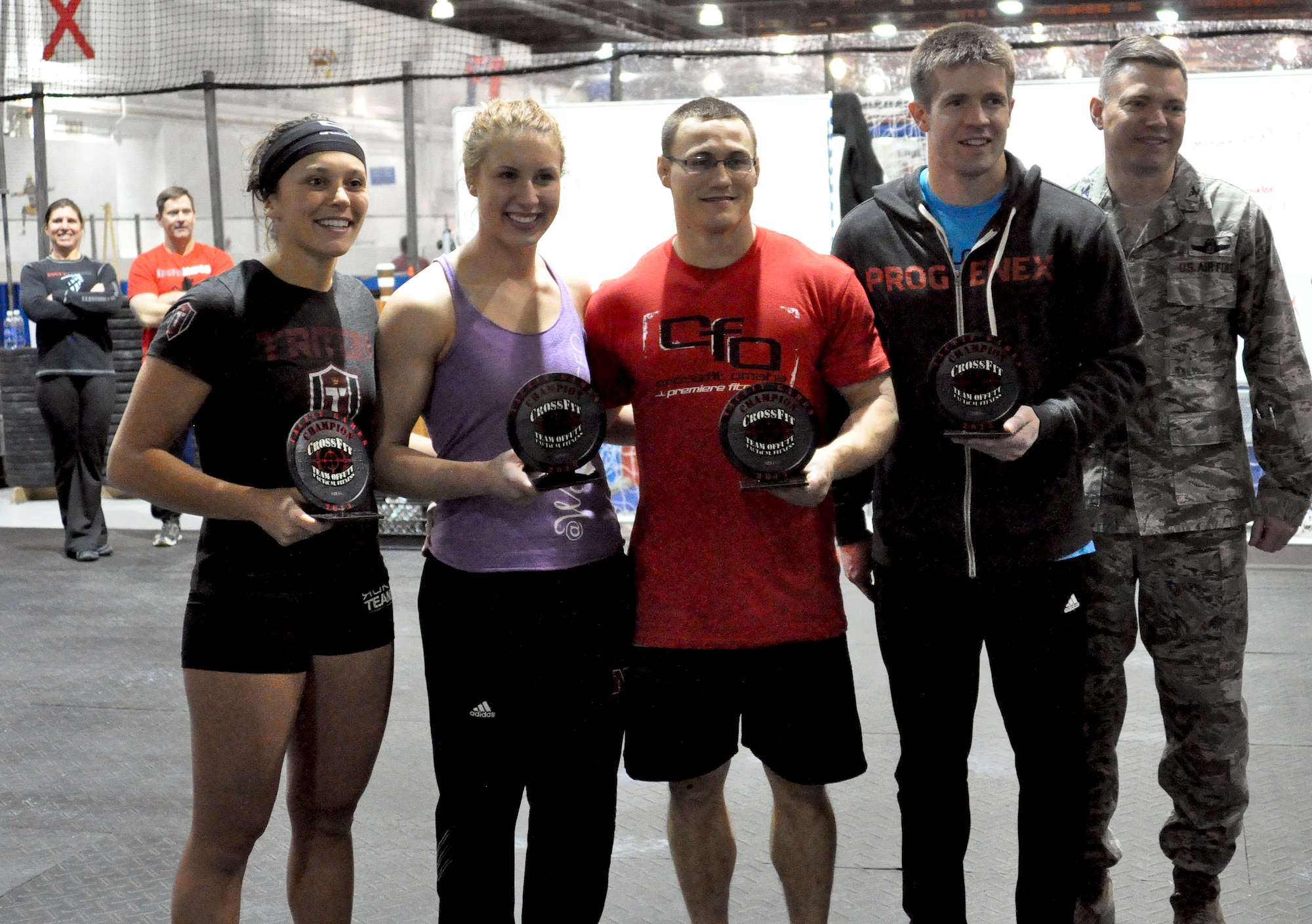 Terra Moyers, Katelyn Busacker, Bryce Teaser and Jonathan Pingel of CrossFit Omaha stand with Col. John Rauch, 55th Wing commander, for a photo after winning first place in the RX division. (U.S. Air Force Photo by 2nd Lt. Carly Costello/Released)
