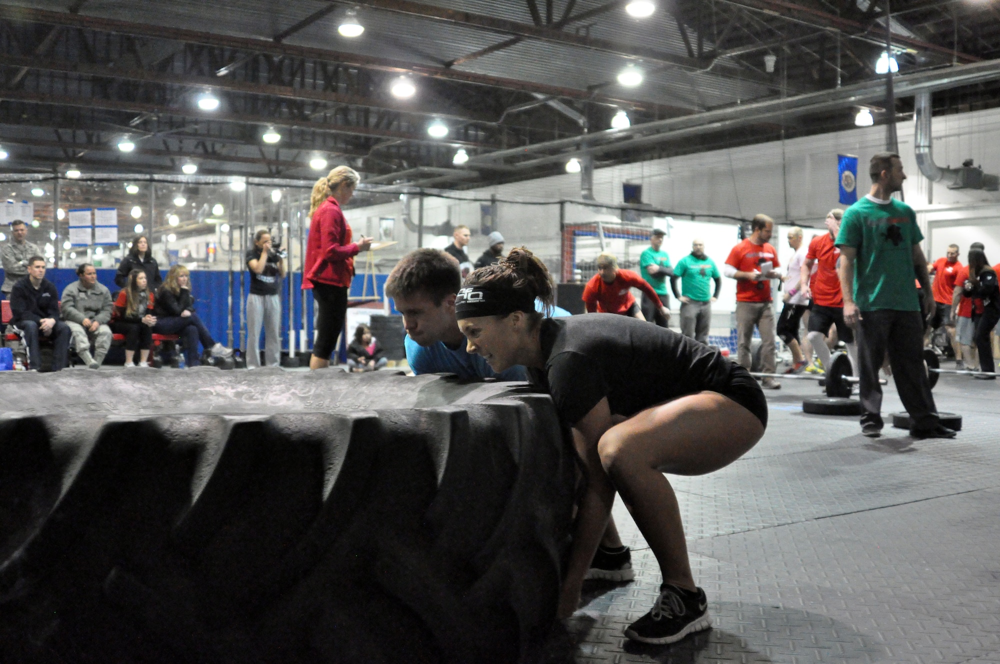 Jonathan Pingel and his teammate Terra Moyers of CrossFit Omaha flip a tractor tire as they fight to win first place for the RX division. (U.S. Air Force Photo by 2nd Lt. Carly Costello/Released)
