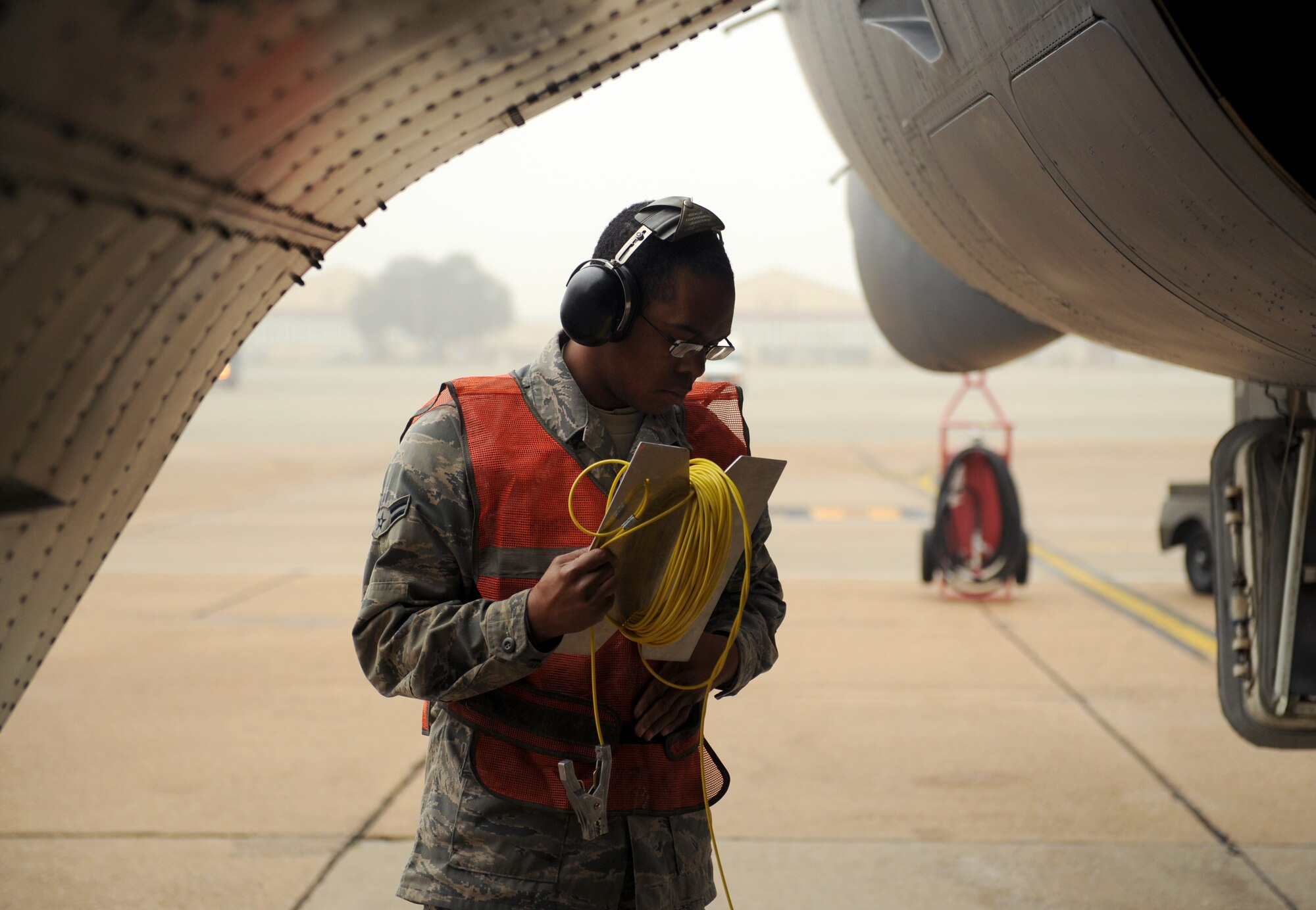 Airman 1st Class Johnny King, 20th Aircraft Maintenance Unit crew chief, wraps up a grounding cable prior to a B-52H Stratofortress launch on Barksdale Air Force Base, La., Jan. 24. The grounding cable is connected to the aircraft to transfer static electricity from the aircraft to the ground while idling. (U.S. Air Force photo/Airman 1st Class Benjamin Gonsier)