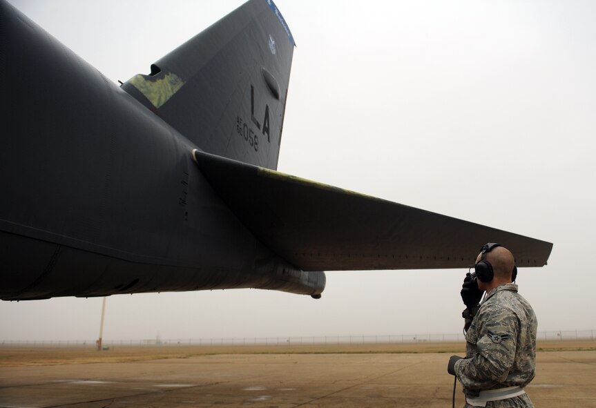 Airman 1st Class Austin Smith, 2nd Maintenance Squadron, communicates with the aircrew as they prepare for launch on Barksdale Air Force Base, La., Jan. 24. The crew chiefs and aircrew communicate during launch procedures to guarantee a safe takeoff. (U.S. Air Force photo/Airman 1st Class Benjamin Gonsier)