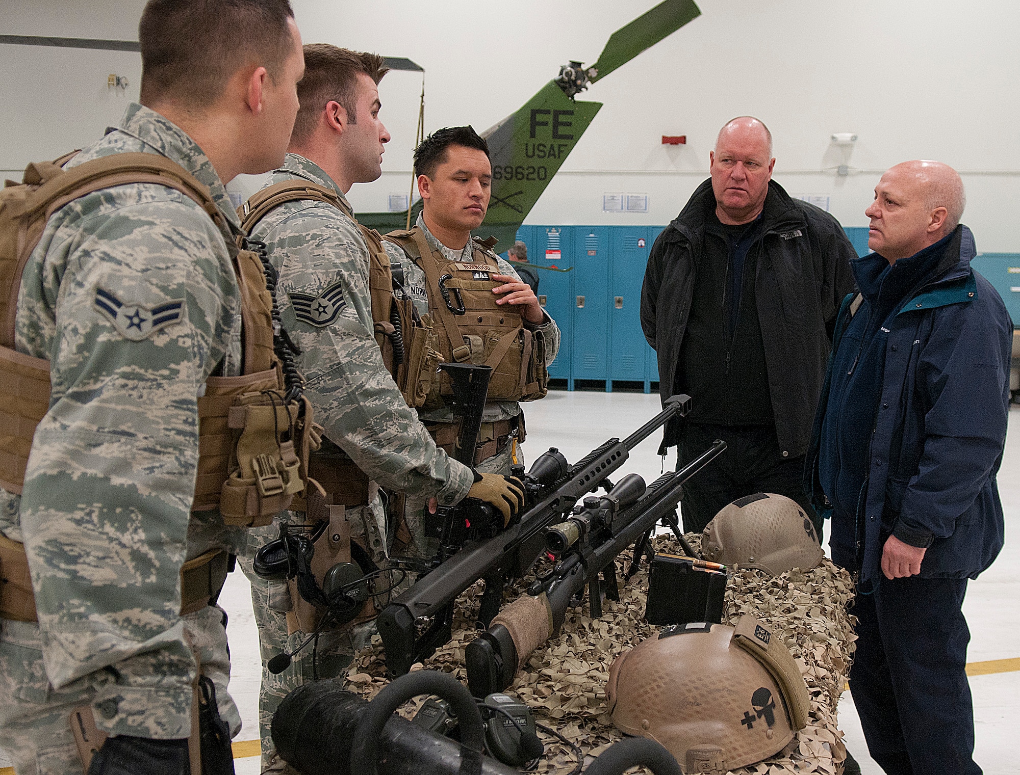 Stewart Kerr, Strategic Weapons Project Team deputy head of logistics and movements, and Peter Jones, Strategic Weapons Security Authority, listen to 90th Security Forces Group tactical response force members Airman 1st Class Jack Robinette, Staff Sgt. Cliff Coppenbarger and Staff Sgt. Jared Norwood brief them on their capabilities and procedures. Kerr and Jones are with the British Ministry of Defence and were visiting F. E. Warren Jan. 16. (U.S. Air Force photo by R.J. Oriez)