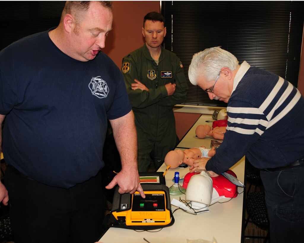 Mr. Gary Broderick (right),914th Airlift Wing Base Communications Security Manager practices Cardio Pulmonary Resuscitation (CPR) on an adult sized training mannequin during a CPR class at the Niagara Falls Air Reserve Station, N.Y. on January 23, 2013. Looking on are Firefighter Captain Steve Check (left) Instructor, NFARS Fire Department and Lt. Colonel George Hoffman (center), 914th Airlift Wing Flying Safety Officer. (U.S. Air Force photo by Peter Borys)