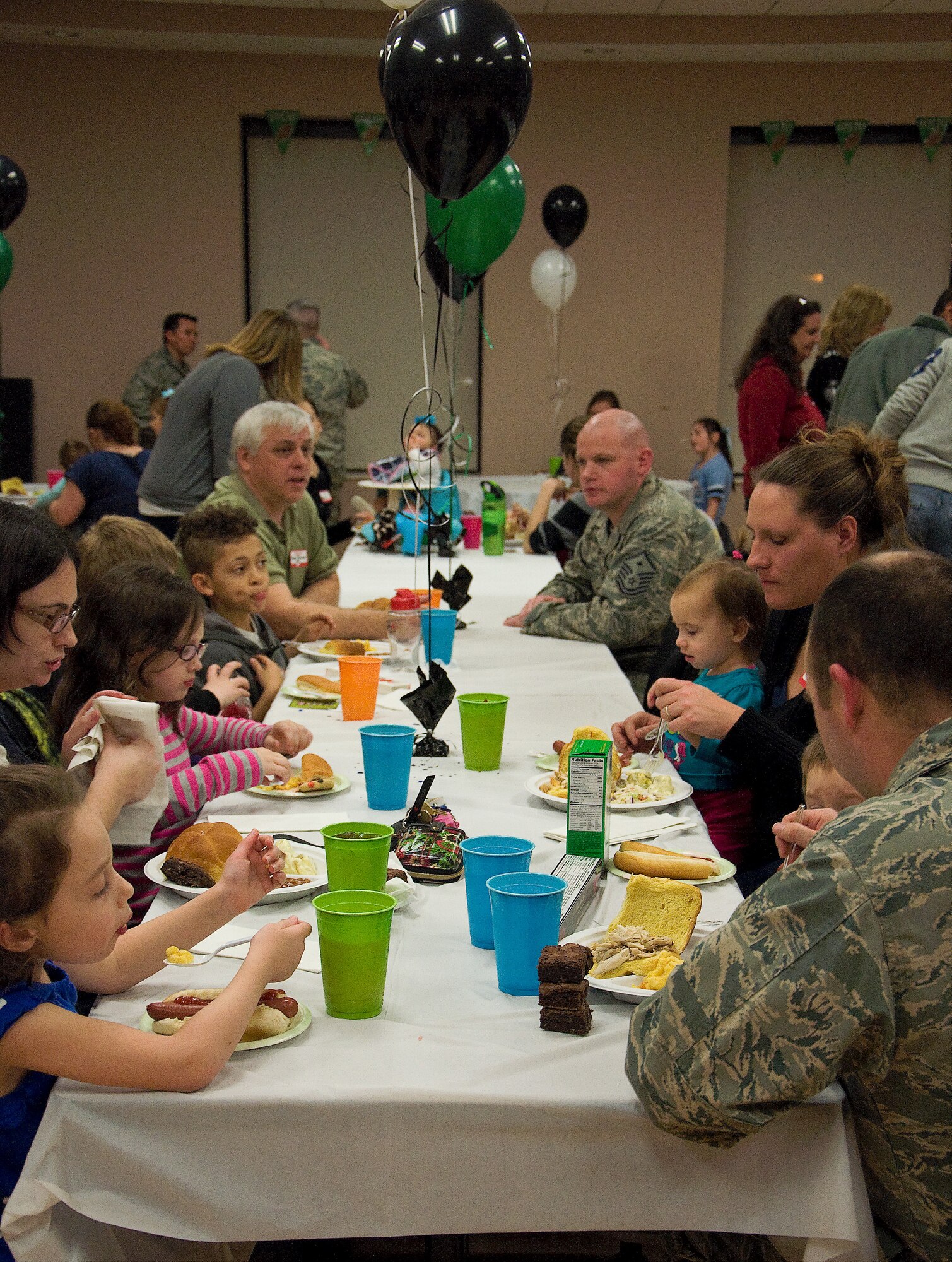 Airmen and spouses join together at a deployed spouses’ dinner Jan. 17, 2013, at the youth center on Dover Air Force Base, Del. The dinner is a free event for families that are separated due to deployment, extended temporary duties, remote tours and projected deployments. (U.S. Air Force photo/Airman 1st Class Ashlin Federick)