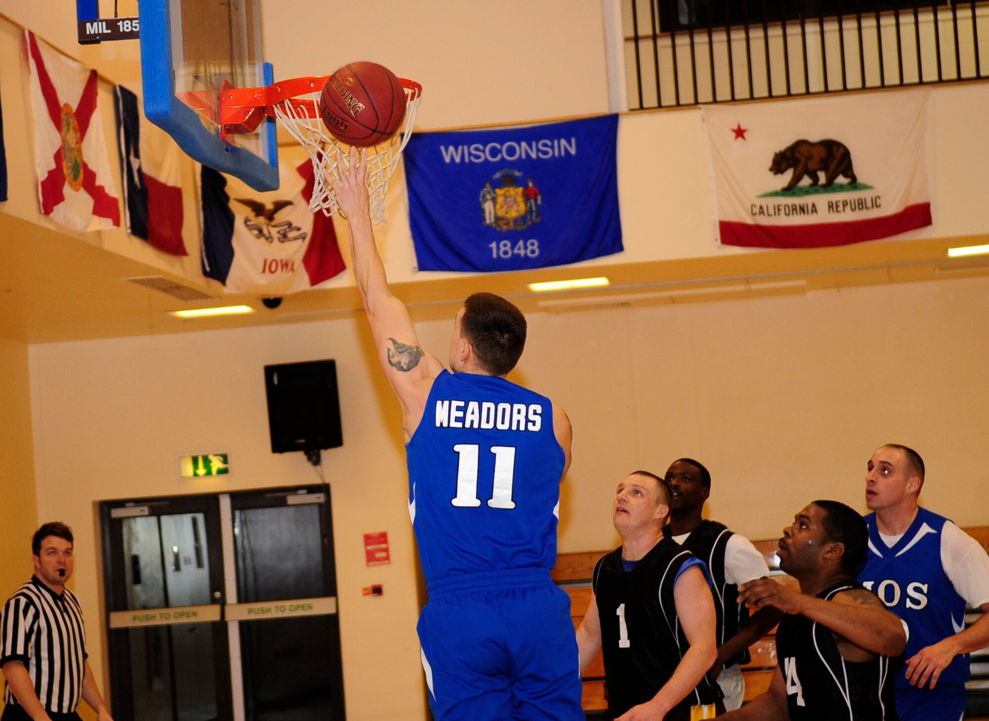 Staff Sgt. Hunter Meadors, 100th Maintenance Operations Squadron maintenance training instructor, jumps to tip the ball into the hoop during an intramural basketball game between the 100th Maintenance Group and the 100th MOS Jan. 24, 2013, at the Hardstand Fitness Center on RAF Mildenhall, England. The 100th Maintenance Group was victorious over the 100th MOS with a final score of 54-28. (U.S. Air Force photo by Airman 1st Class Dillon Johnston/Released)