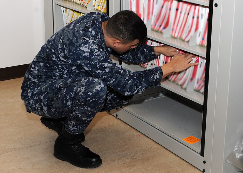 Petty Officer 1st Class Ruben Leyvaa, Navy Operatons Support Center hospital corpsman, searches for a medical record Jan. 16 in the medical records vault on Luke Air Force Base. The NOSC has a medical unit for Navy reservists to visit on reserve weekends to attend to medical issues. (U.S. Air Force photo/Airman 1st Class Devante Williams)