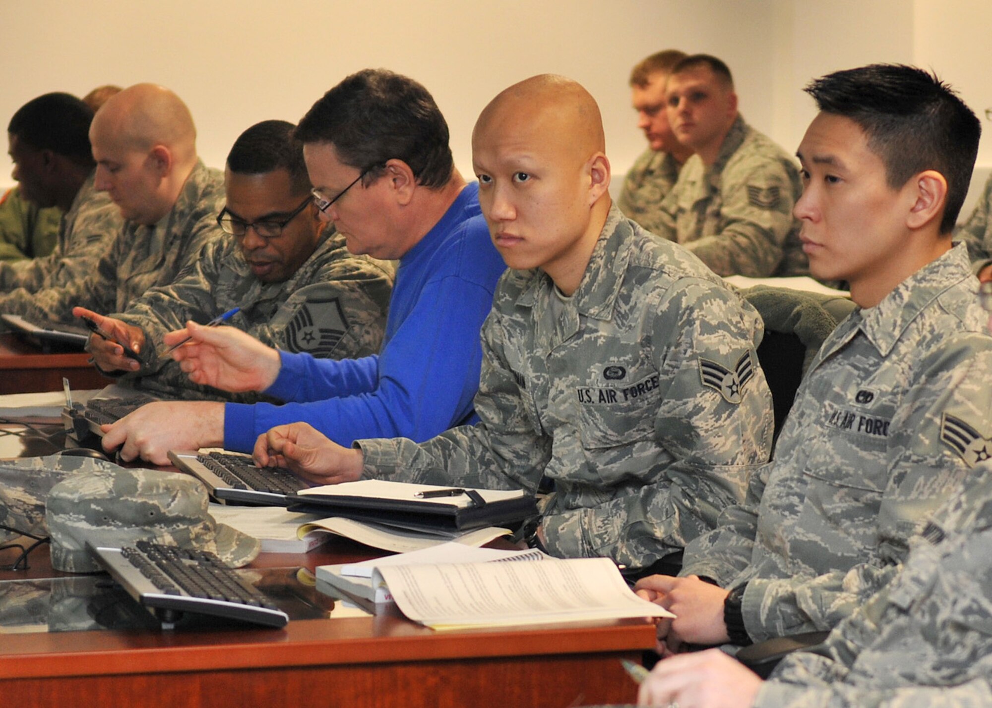 Volunteer Income Tax Assistance office volunteers sit through a training course Jan. 11, 2013, at RAF Lakenheath, England. Participants from RAF Mildenhall and RAF Lakenheath were required to complete the four-day training course which consisted of certification tests and a standards-of-conduct course. (U.S. Air Force photo by Senior Airman Jerilyn Quintanilla/Released)