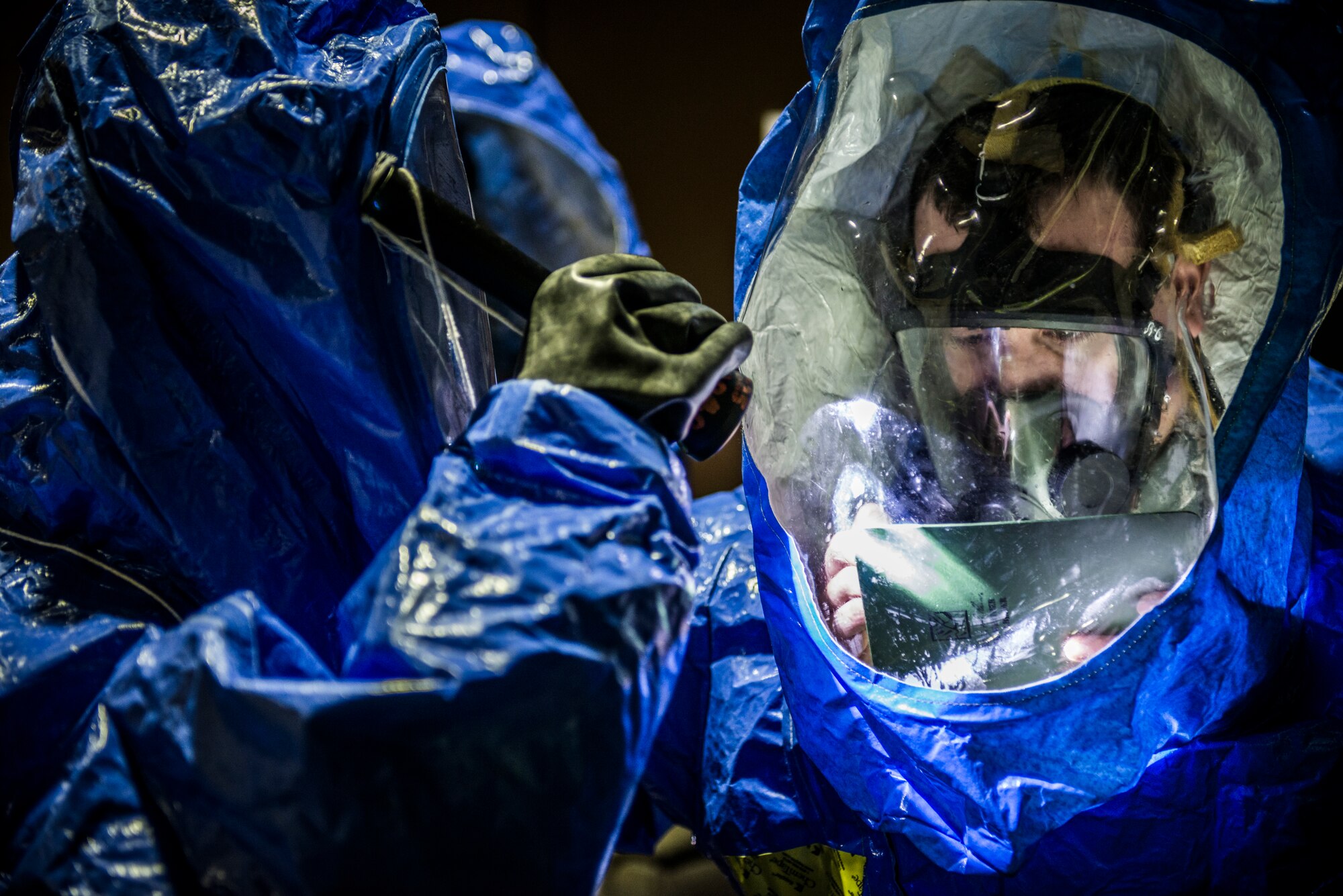YOKOTA AIR BASE, Japan -- Airmen from the 374th Aerospace Medicine Squadron work together to write down their findings in a simulated contaminated environment during an emergency management exercise at Yokota Air Base, Japan, Jan. 22, 2013. The exercise evaluation team crafts scenarios to test every aspect of an emergency response while simulating the pace and stress of a real-life emergency. (U.S. Air Force photo by Tech. Sgt. Samuel Morse)