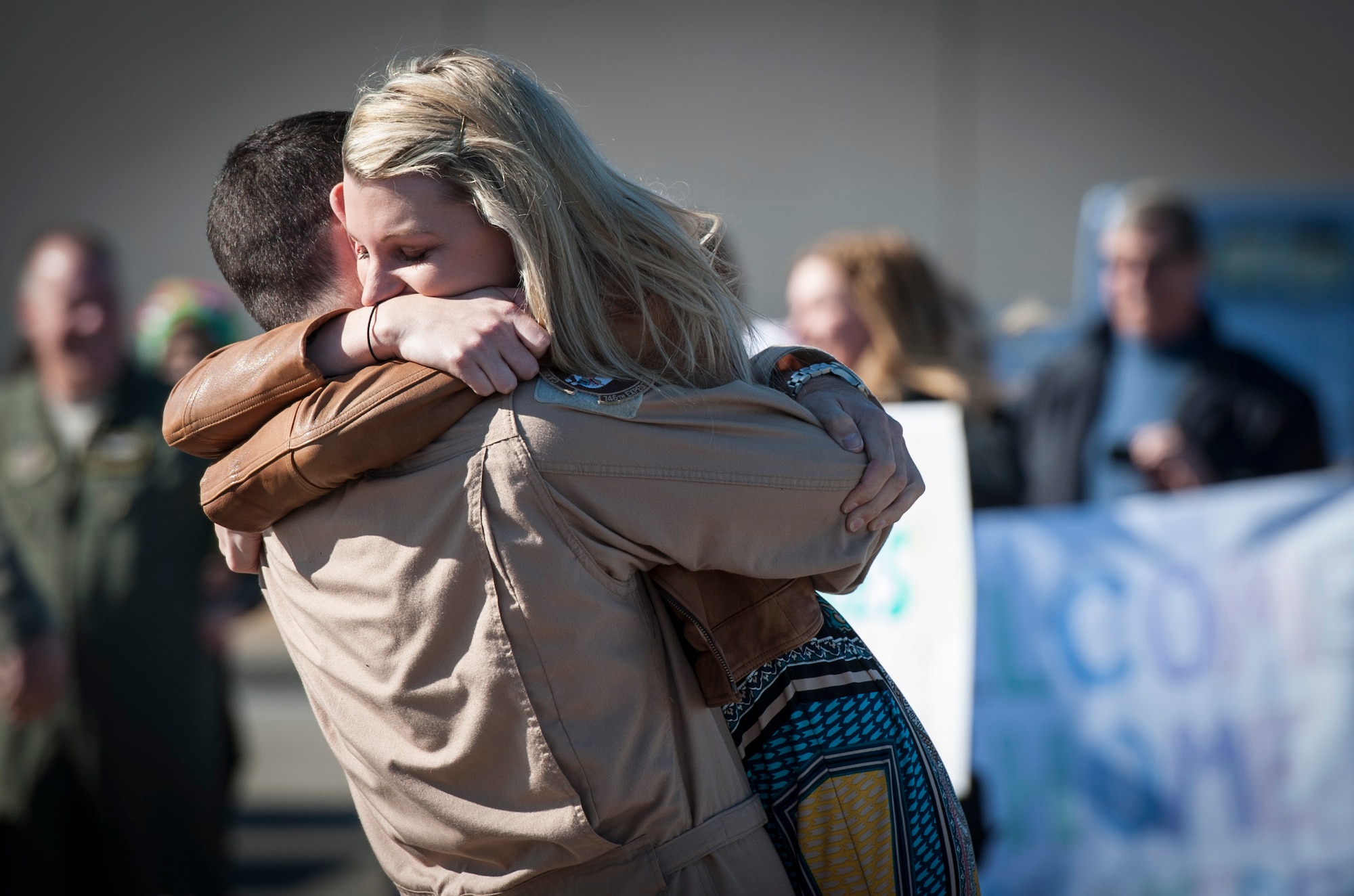 YOKOTA AIR BASE, Japan -- A returning Airman hugs his wife at Yokota Air Base, Japan, Jan. 19, 2013. He had just returned from deployment to Southwest Asia. (U.S. Air Force photo by Tech. Sgt. Samuel Morse)