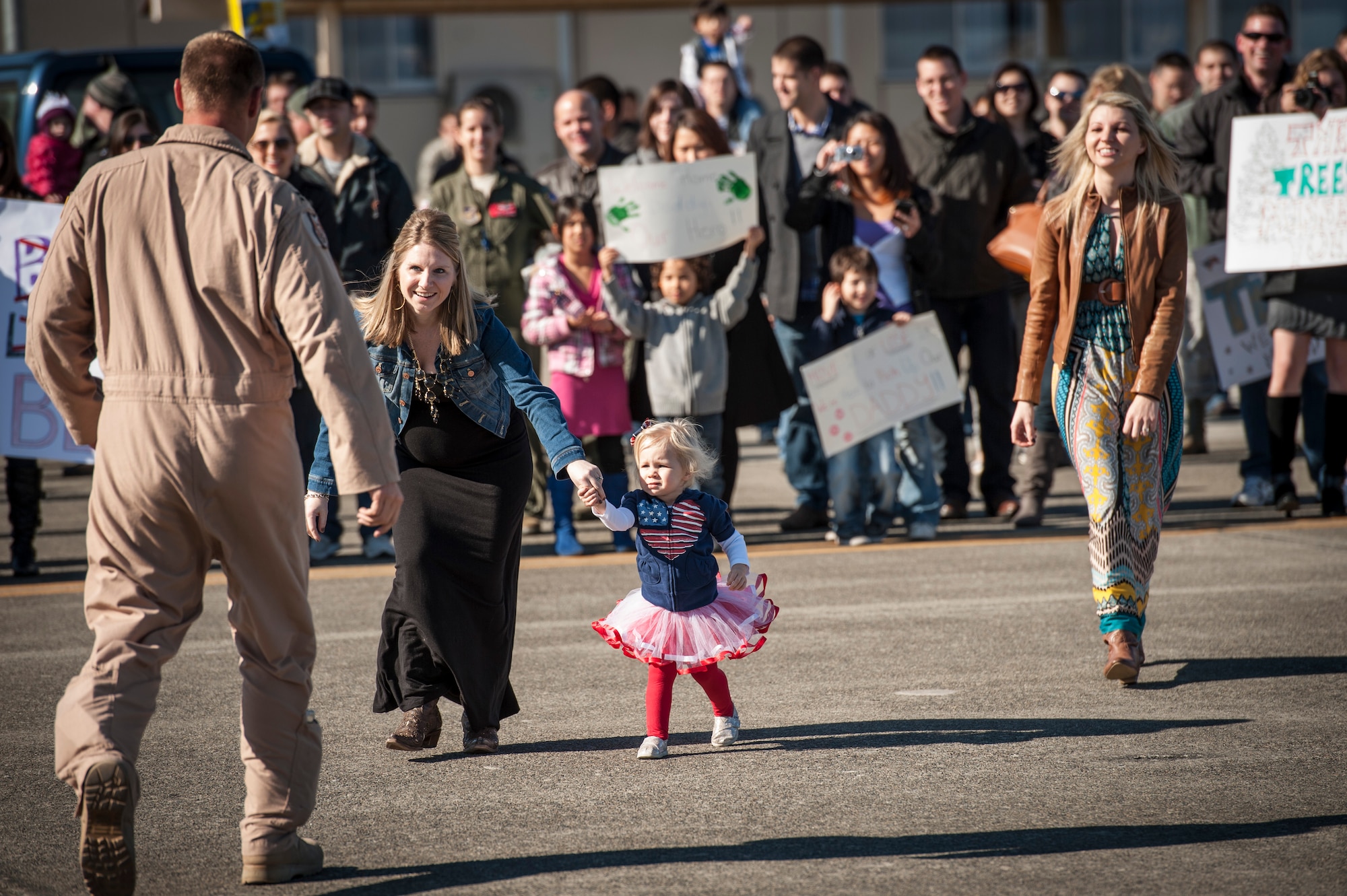 YOKOTA AIR BASE, Japan -- Family members rush toward their loved ones at Yokota Air Base, Japan, Jan. 19, 2013. A C-130 Hercules carried personnel returning from deployment to Southwest Asia. (U.S. Air Force photo by Tech. Sgt. Samuel Morse)