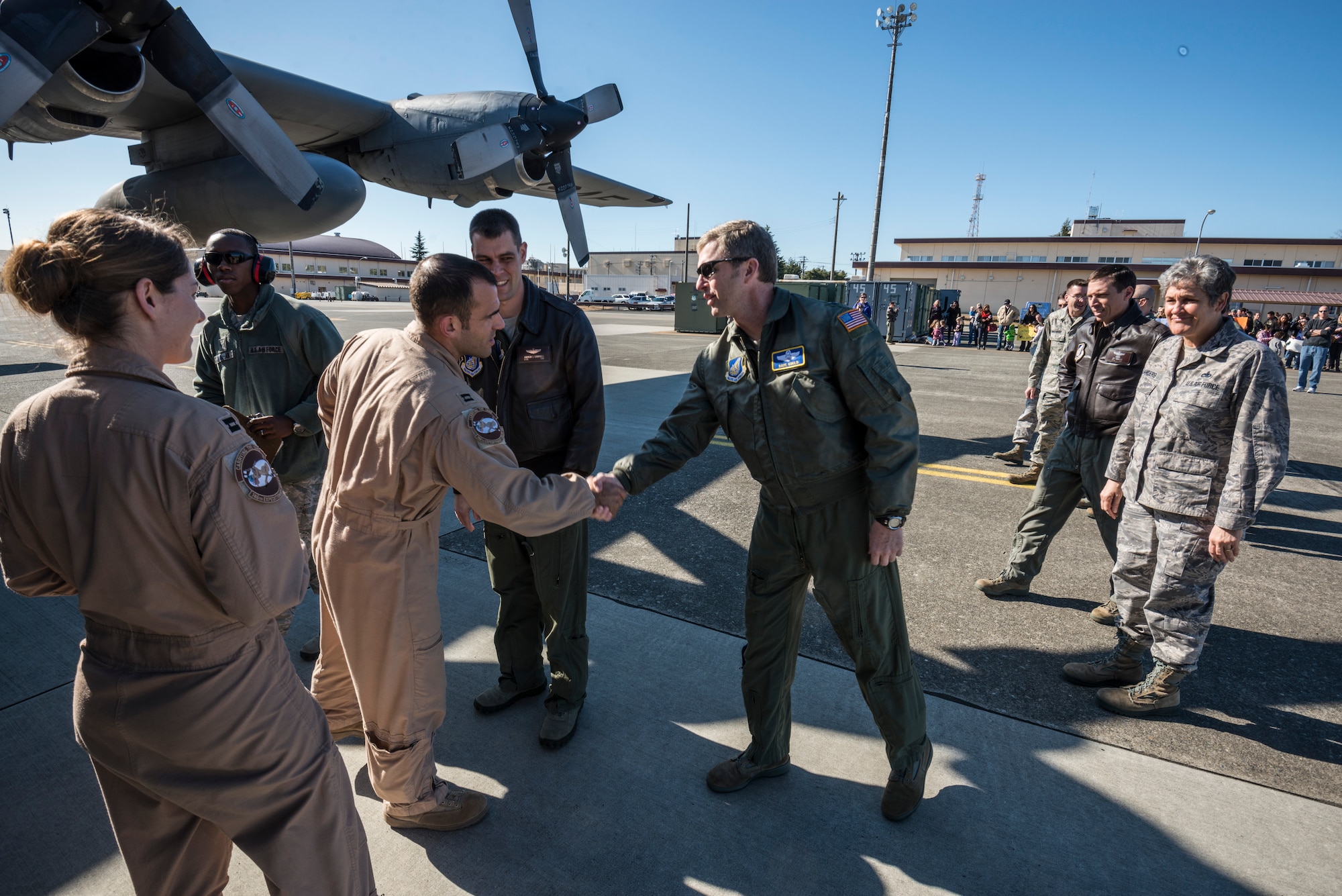 YOKOTA AIR BASE, Japan -- Col. David Gould, center-right, 374th Operations Group commander, shakes hands with the first Airmen to deplane at Yokota Air Base, Japan, Jan. 19, 2013. The C-130 Hercules carried personnel returning from deployment to Southwest Asia. (U.S. Air Force photo by Tech. Sgt. Samuel Morse)