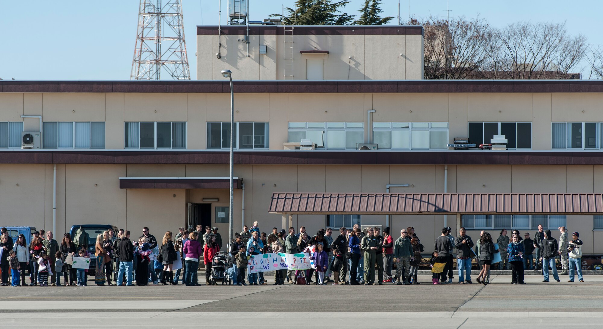 YOKOTA AIR BASE, Japan -- A crowd waits for their loved ones at Yokota Air Base, Japan, Jan. 19, 2013. A C-130 Hercules returned to Yokota that day carrying personnel returning from deployment to Southwest Asia. (U.S. Air Force photo by Tech. Sgt. Samuel Morse)