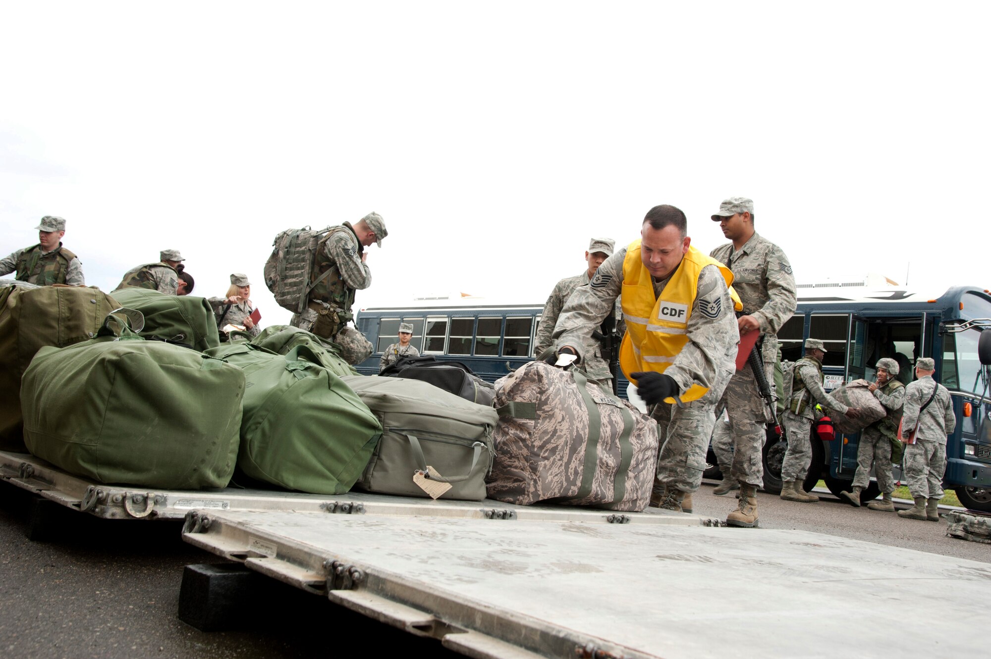 VANDENBERG AIR FORCE BASE, Calif. – Team V chalk 2 loads their personal baggage onto a pallet at the Personnel Deployment Function line for the unit compliance inspection exercise deployment here Friday, Jan. 25, 2013. A mobility bag consists of items essential for an Airman to have when tasked to deploy at a moments notice. (U.S. Air Force photo/Senior Airman Lael Huss)
