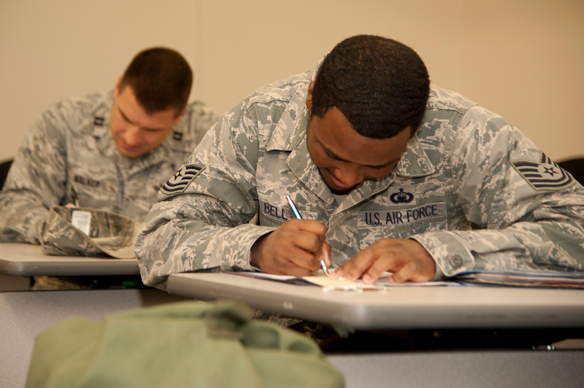 VANDENBERG AIR FORCE BASE, Calif. – Tech. Sgt. Jeffery Bell, the 30th Chapel NCO in charge of financial management, writes information into his mobility folder during a bag-drag here Friday, Jan. 25, 2013. A mobility bag consists of items essential for an Airman to have when tasked to deploy at a moments notice. (U.S. Air Force photo/Senior Airman Lael Huss)