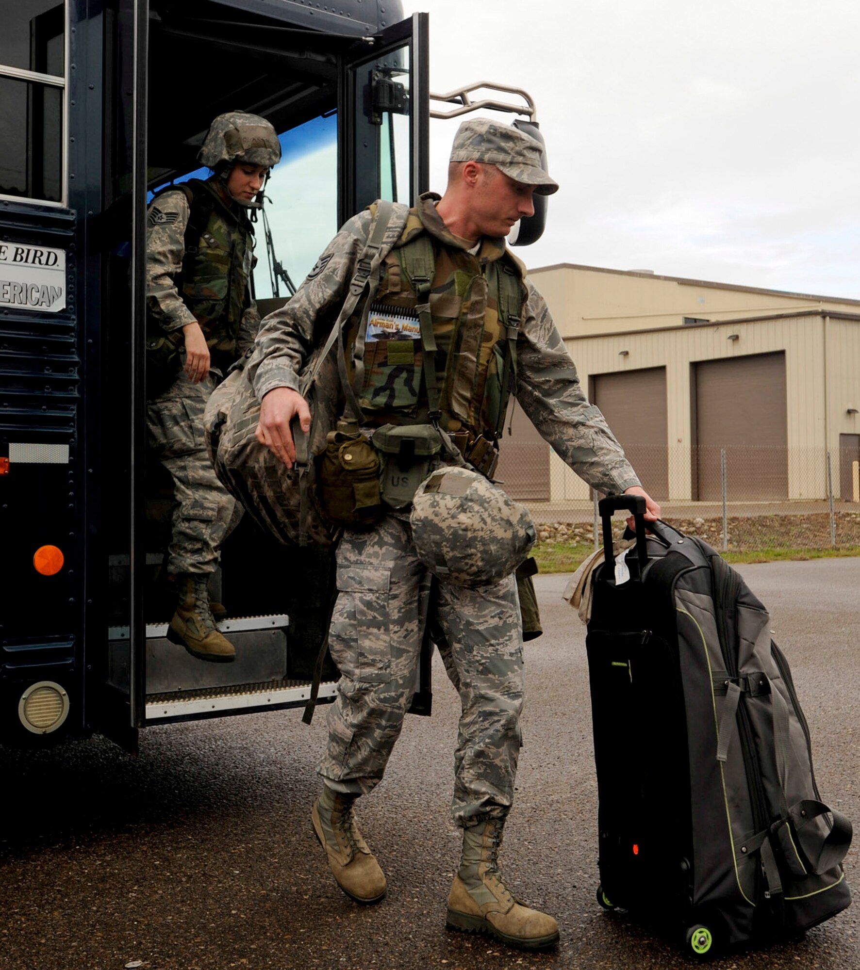 VANDENBERG AIR FORCE BASE, Calif. – Team V personnel disembark from a bus headed for the Personnel Deployment Function line here Friday, Jan. 25, 2013. A mobility bag consists of items essential for an Airman to have when tasked to deploy at a moments notice. (U.S. Air Force photo/Airman Yvonne Morales)