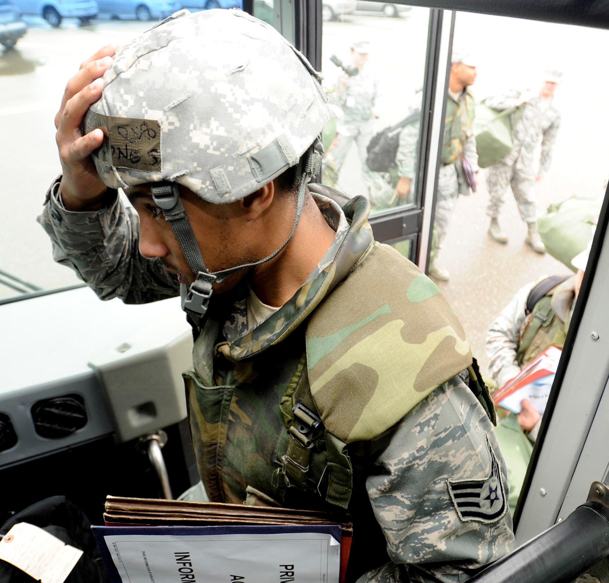 VANDENBERG AIR FORCE BASE, Calif. – Staff Sgt. Tony Jones, the 30th Comptroller Squadron NCO in charge of customer service, boards a bus bound for the Personnel Deployment Function line here Friday, Jan. 25, 2013. A mobility bag consists of items essential for an Airman to have when tasked to deploy at a moments notice. (U.S. Air Force photo/Airman Yvonne Morales)