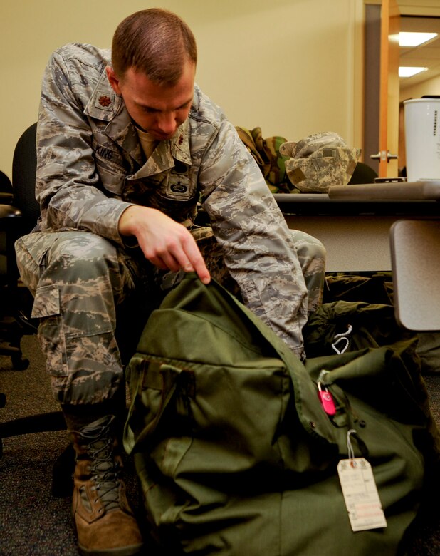 VANDENBERG AIR FORCE BASE, Calif. – Maj. Michael King, the 30th Staff Judge Advocate deputy, goes through his mobility bag at the 30th Comptroller Squadron here Friday, Jan. 25, 2013. A mobility bag consists of items essential for an Airman to have when tasked to deploy at a moments notice. (U.S. Air Force photo/Airman Yvonne Morales)