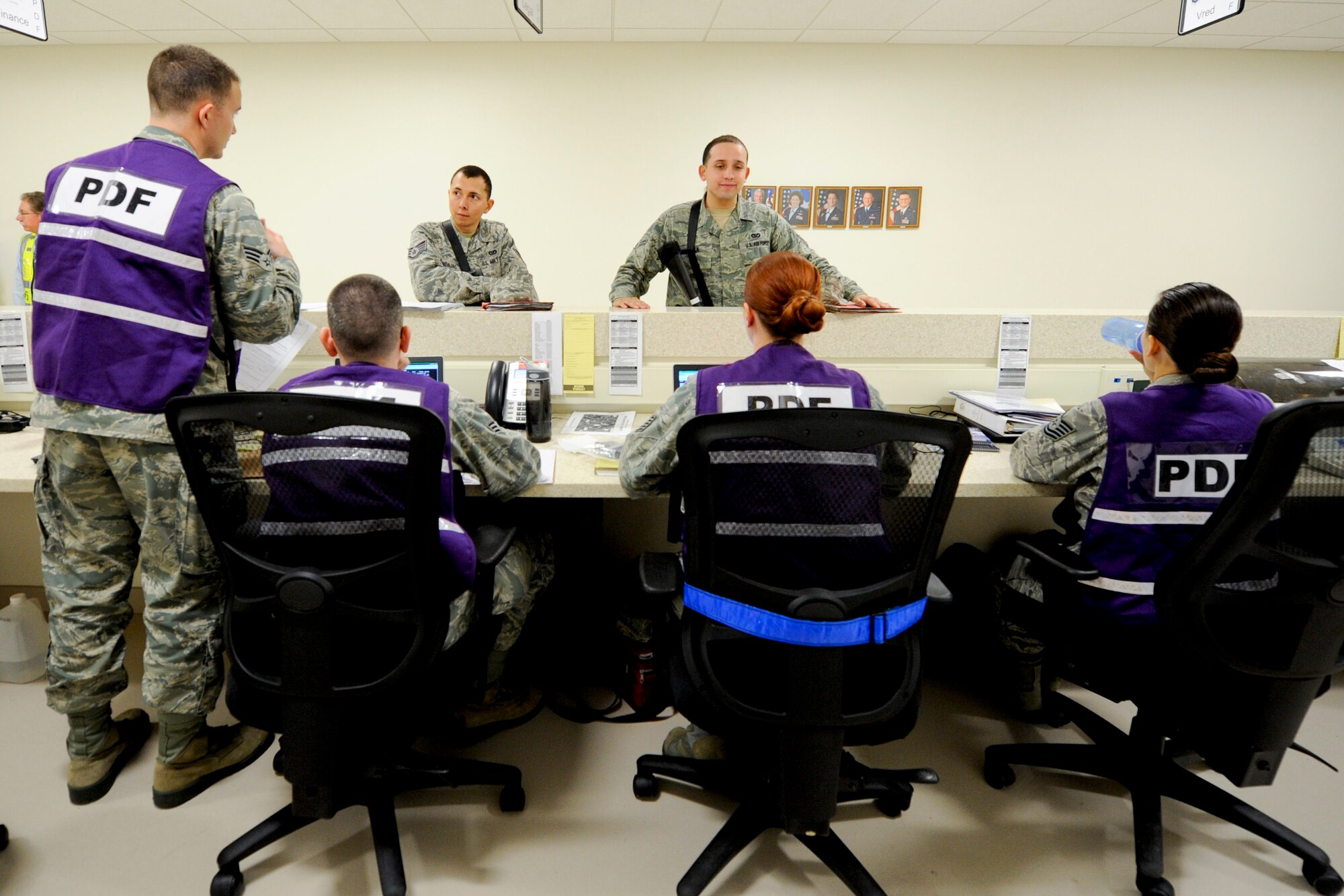 VANDENBERG AIR FORCE BASE, Calif. -- 30th Security Force Squadron members process through the Personnel Deployment Function line during an exercise here Friday, Jan. 25, 2013. The PDF line was held as part of a Consolidated Unit Inspection, a biannual inspection used to measure the base's discipline, readiness and war fighting capability through exercises, inspection and evaluations. (U.S. Air Force photo/Staff Sgt. Levi Riendeau)
