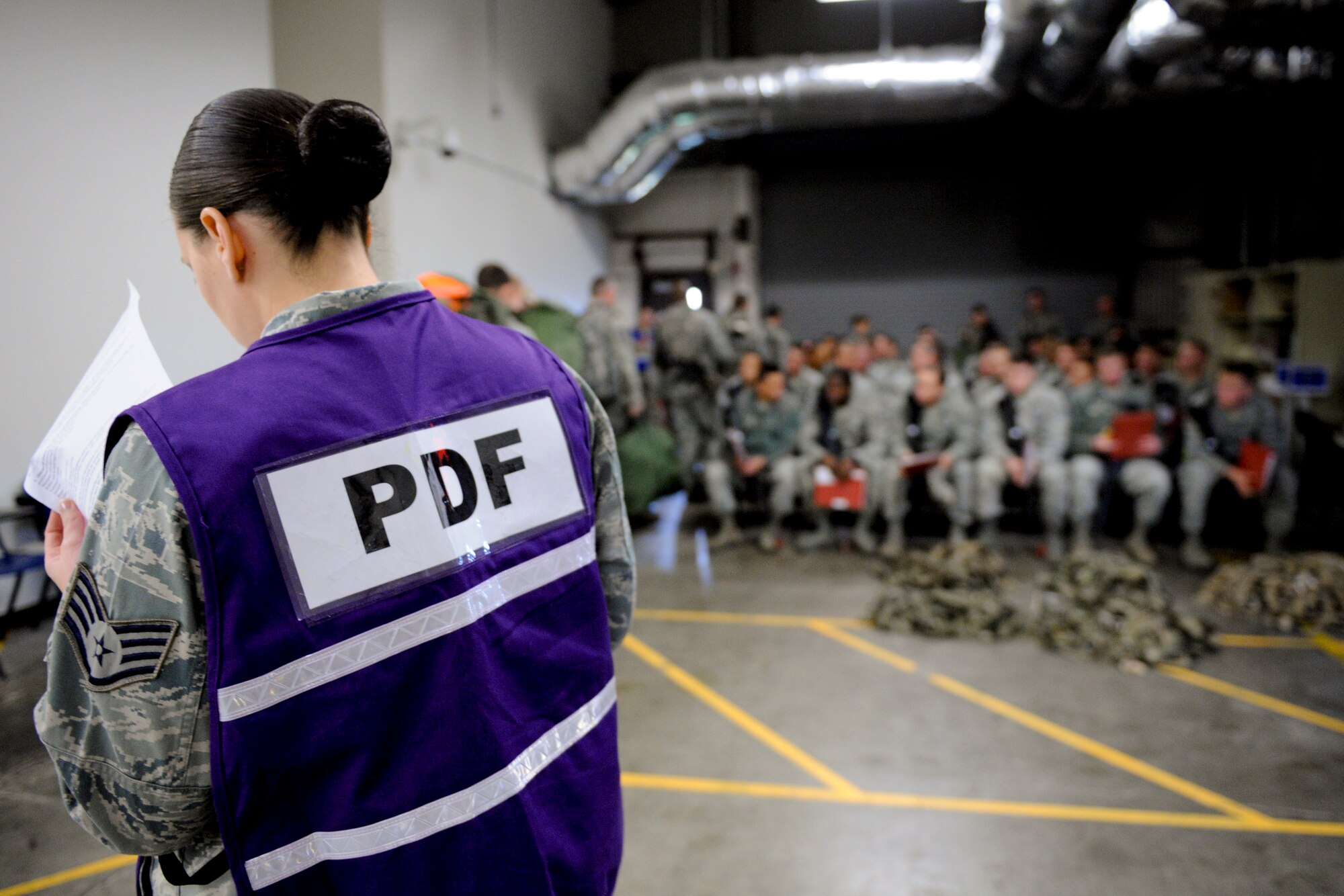 VANDENBERG AIR FORCE BASE, Calif. -- Staff Sgt. Crystale Samuel, a 30th Force Support Squadron member, briefs deployers before they process through the Personnel Deployment Function line during an exercise here Friday, Jan. 25, 2013. The PDF line was held as part of a Consolidated Unit Inspection, a biannual inspection used to measure the base's discipline, readiness and war fighting capability through exercises, inspection and evaluations. (U.S. Air Force photo/Staff Sgt. Levi Riendeau)
