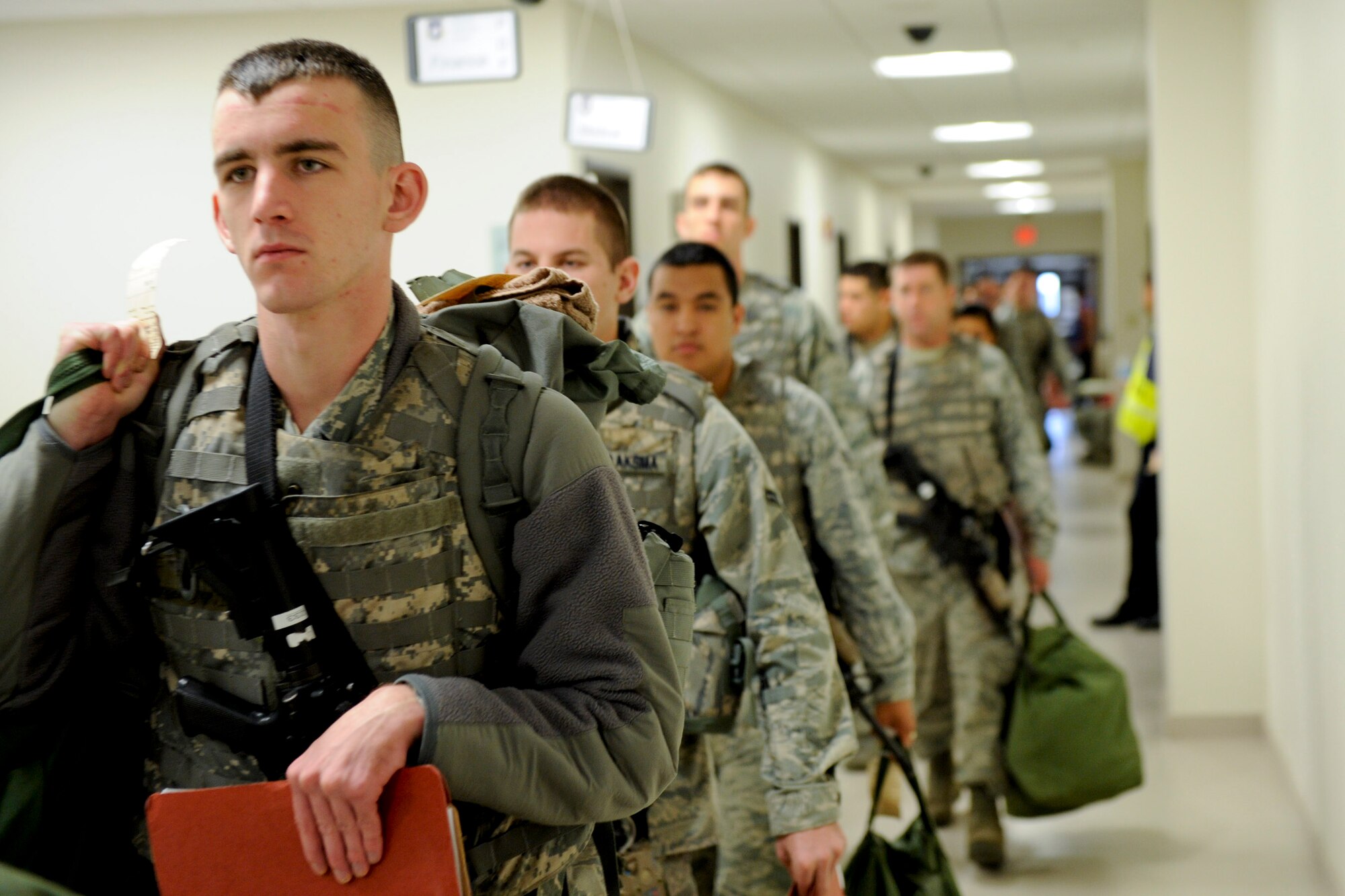 VANDENBERG AIR FORCE BASE, Calif. -- 30th Security Force Squadron members walk to a briefing area before processing through the Personnel Deployment Function line during an exercise here Friday, Jan. 25, 2013. The PDF line was held as part of a Consolidated Unit Inspection, a biannual inspection used to measure the base's discipline, readiness and war fighting capability through exercises, inspection and evaluations. (U.S. Air Force photo/Staff Sgt. Levi Riendeau)
