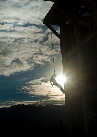 Ismael Cano, Junior Reserve Officer Training Corps cadet, rappels from a tower during a visit to Nellis Air Force Base, Nev., Jan. 25, 2013. The 58th Rescue Squadron Airmen volunteered to provide the rappelling experience to JROTC cadets from various schools in the Las Vegas area. (U.S. Air Force photo/Senior Airman Brett Clashman)