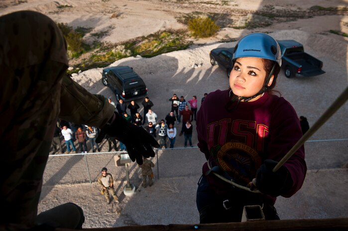 Melody Oberg, Junior Reserve Officer Training Corps cadet, listens to verbal instructions from a 58th Rescue Squadron pararescueman during a visit to Nellis Air Force Base, Nev., Jan. 25, 2013. Approximately 100 JROTC cadets visited Nellis to experience a day-in-the-life of active duty military. (U.S. Air Force photo/Senior Airman Brett Clashman)