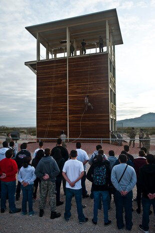 Junior Reserve Officer Training Corps cadets from various schools in the Las Vegas area observe 58th Rescue Squadron pararescuemen demonstrate rappelling during a visit Jan. 25, 2013, at Nellis Air Force Base, Nev. Nellis hosted JROTC cadets to experience a day-in-the-life of active duty military. (U.S. Air Force photo/Senior Airman Brett Clashman)