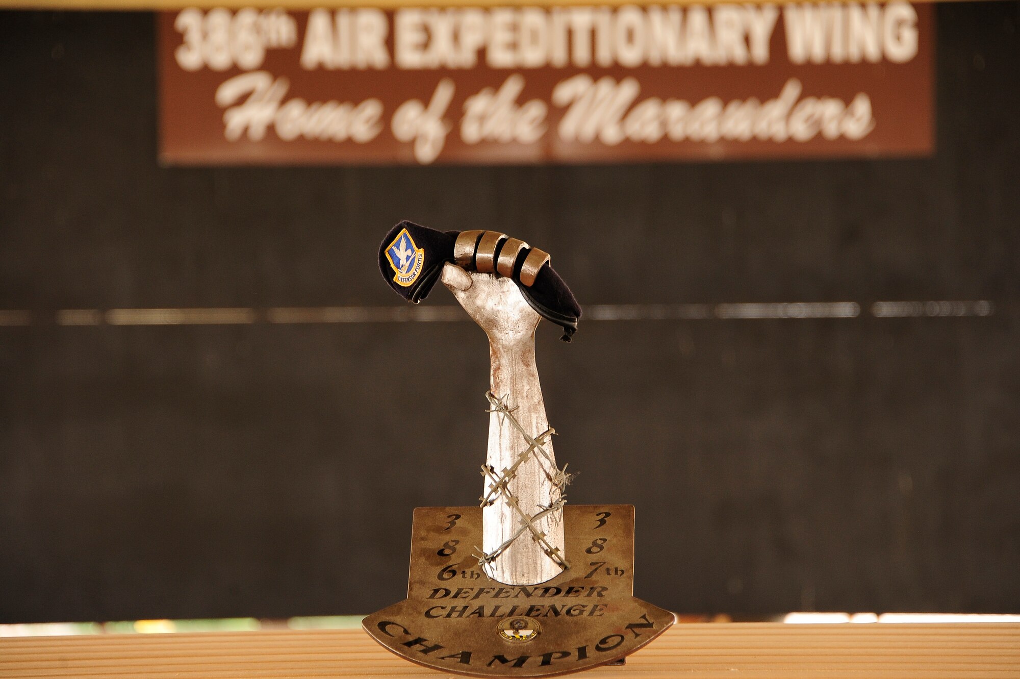 The 386th Air Expeditionary Wing and 387th Air Expeditionary Group Defender's Challenge trophy. The Defender’s Challenge pitted ten four-person fire teams, in a six event timed competition consisting of a gear relay, Humvee push and down gunner litter relay, weapons knowledge, unexploded ordnance recognition and a job knowledge questionnaire. (U.S. Air Force photo by Senior Master Sgt. George Thompson)