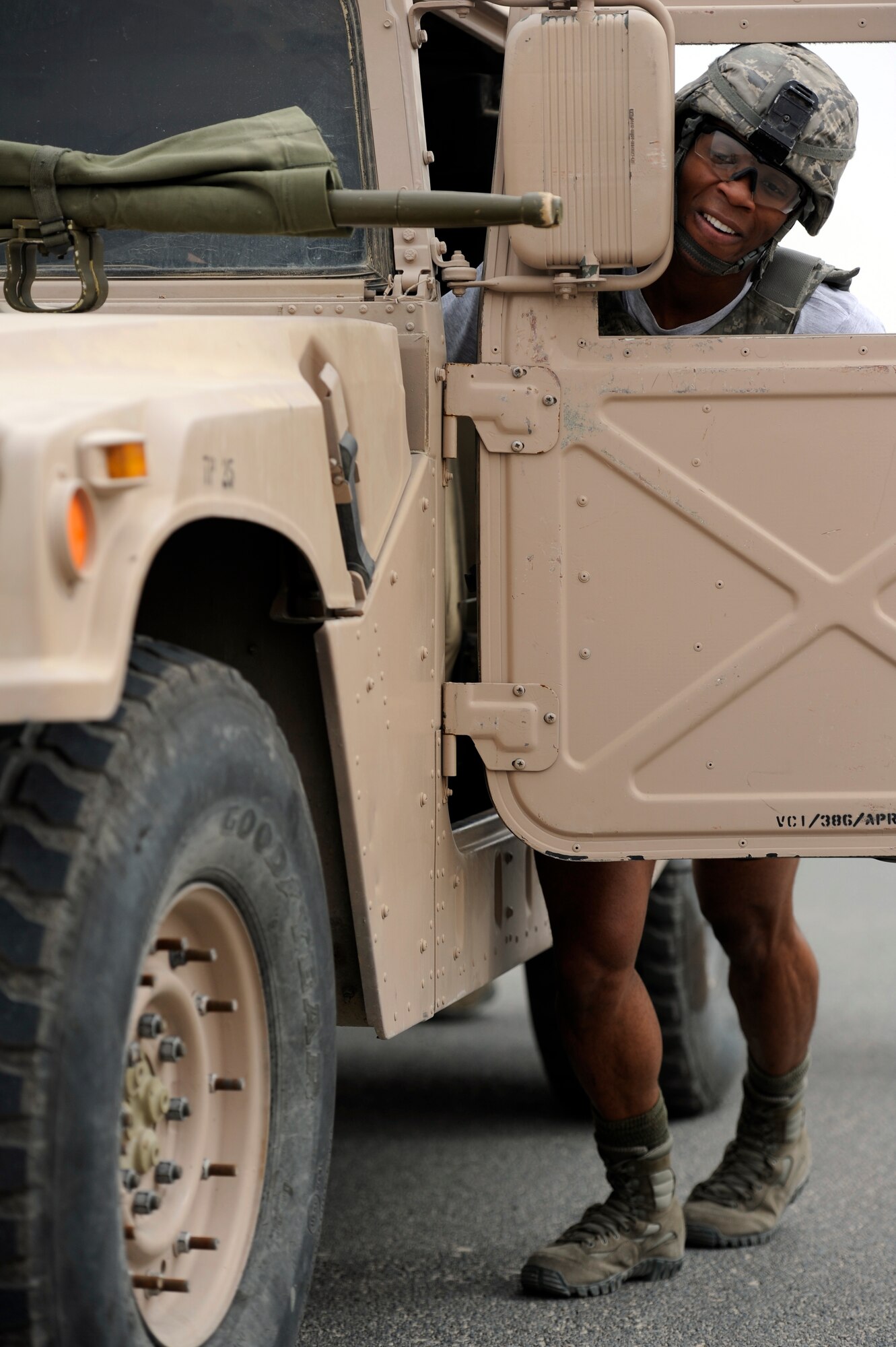 Staff Sgt. Richard Hobbs, 387th Expeditionary Security Forces Squadron, pushes a Humvee during the Defender's Challenge competition at the 386th Air Expeditionary Wing. The Defender’s Challenge pitted ten four-person fire teams, in a six event timed competition consisting of a gear relay, Humvee push and down gunner litter relay, weapons knowledge, unexploded ordnance recognition and a job knowledge questionnaire. (U.S. Air Force photo by Staff Sgt. Austin Knox)
