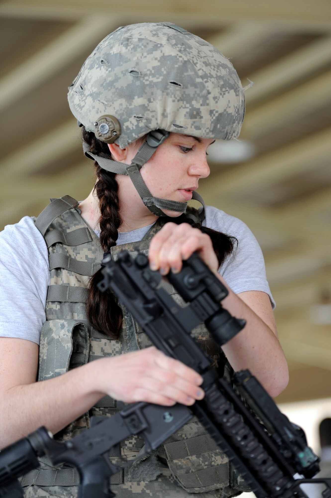 Senior Airman Olivia Gill, 387th Expeditionary Security Forces Squadron, assembles a M-4 Carbine during the Defender's Challenge competition at the 386th Air Expeditionary Wing. The Defender’s Challenge pitted ten four-person fire teams, in a six event timed competition consisting of a gear relay, Humvee push and down gunner litter relay, weapons knowledge, unexploded ordnance recognition and a job knowledge questionnaire. (U.S. Air Force photo by Staff Sgt. Austin Knox)