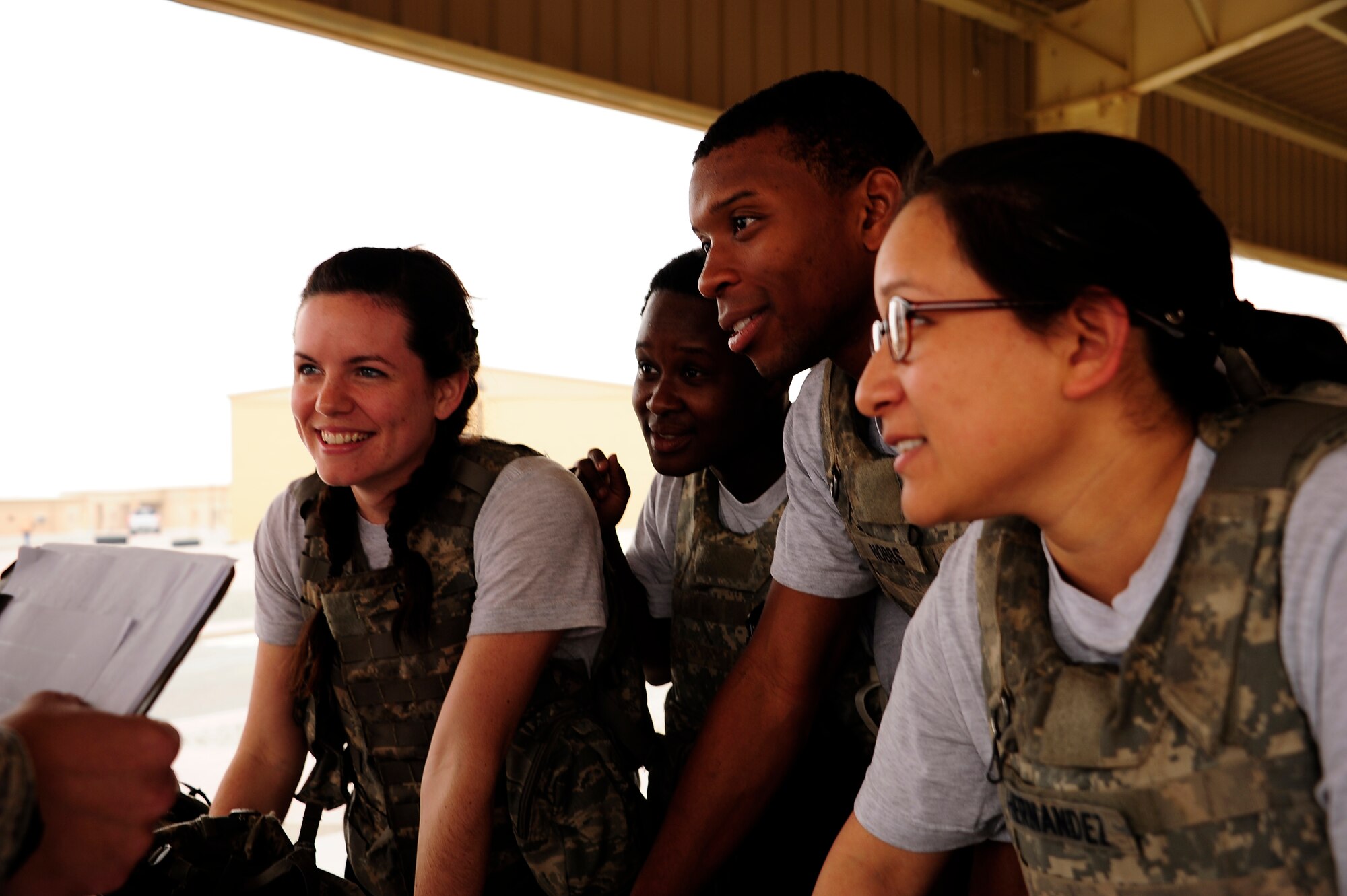 Team Six, 387th Expeditionary Security Forces Squadron, answers weapons knowledge questions during the Defender's Challenge competition at the 386th Air Expeditionary Wing. The Defender’s Challenge pitted ten four-person fire teams, in a six event timed competition consisting of a gear relay, Humvee push and down gunner litter relay, weapons knowledge, unexploded ordnance recognition and a job knowledge questionnaire. (U.S. Air Force photo by Senior Master Sgt. George Thompson)