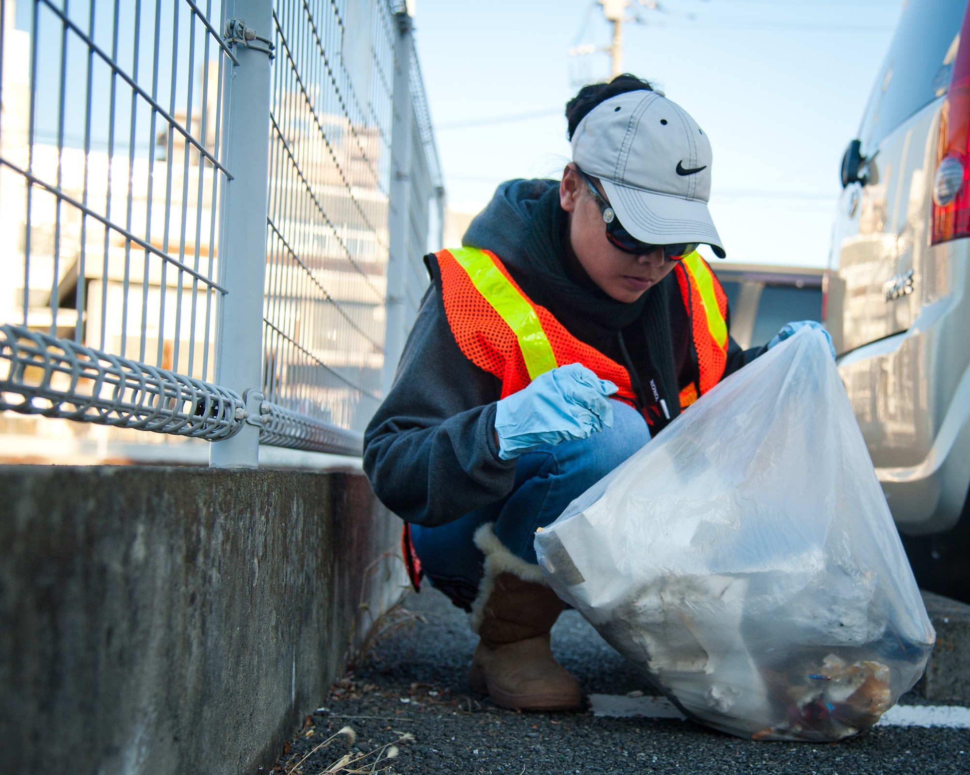 FUSSA CITY, Japan – Louisa Hazel, Yokota Air Base Teen Center youth program assistant, removes trash from a parking lot at Fussa City, Japan, Jan. 19, 2013.  Roughly 20 volunteers participated in the event to improve the local community.  (U.S. Air Force photo by Airman 1st Class Soo C. Kim)