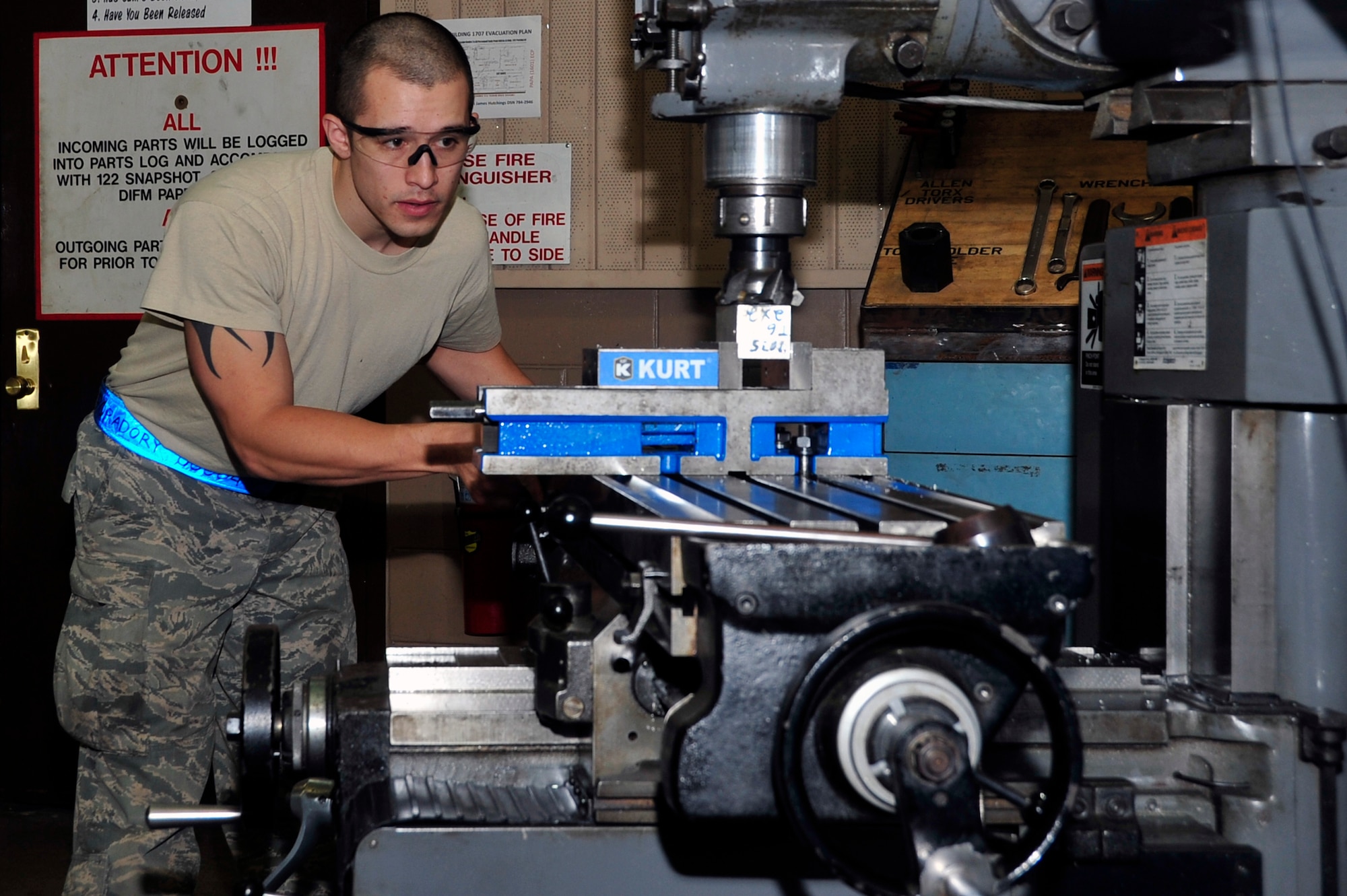 Senior Airman Henry Foradory, 51st Maintenance Squadron aircraft metals technology journeyman, uses a mill to level out a piece of metal at Osan Air Base, Republic of Korea, Jan. 23, 2013. The shop produces bushings, brackets and can perform precision measuring. (U.S. Air Force photo/Airman 1st Class Alexis Siekert)