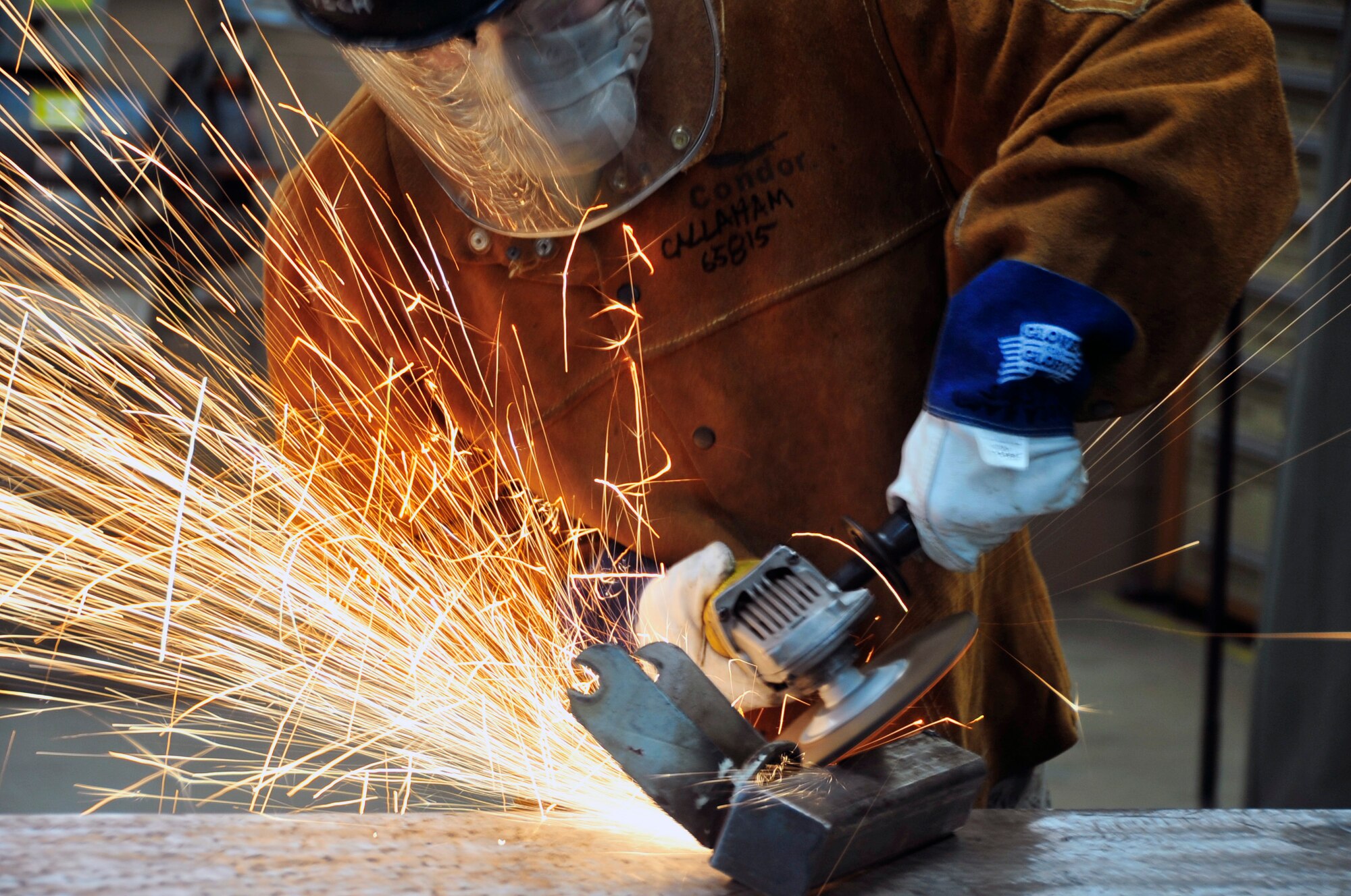Senior Airman Jared Callaham, 51st Maintenance Squadron aircraft metals technology journeyman, grinds a part after welding it at Osan Air Base, Republic of Korea, Jan. 23, 2013. The metals technology shop does a combination of on-aircraft work and in-shop fabrication. (U.S. Air Force photo/Airman 1st Class Alexis Siekert)