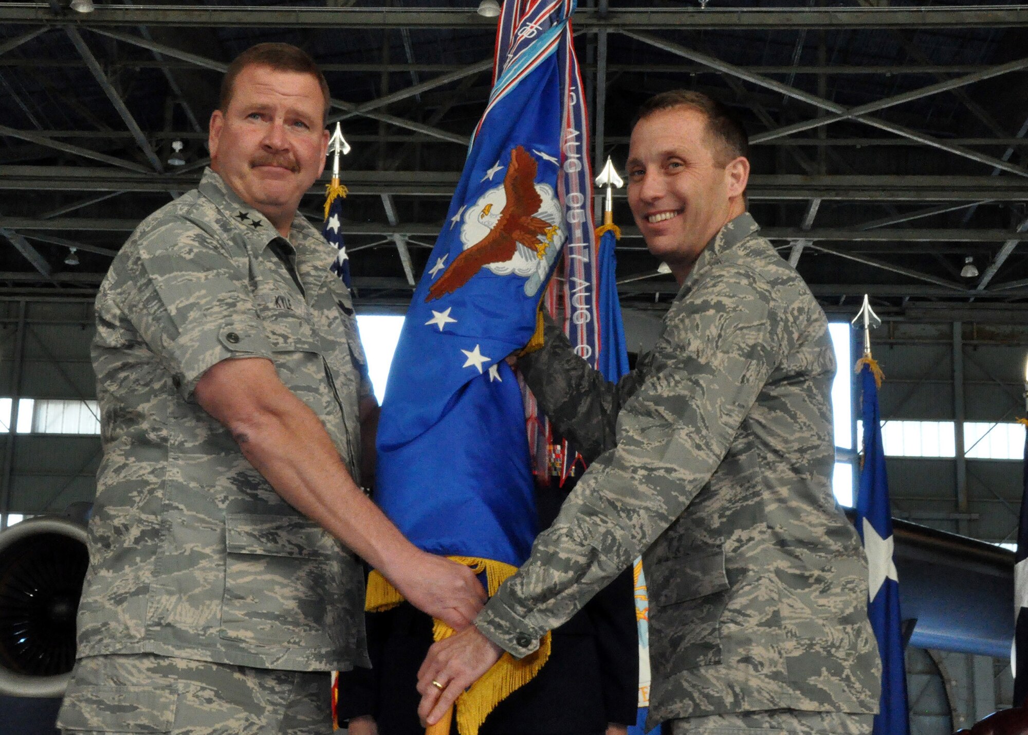 In a ceremony symbolizing the transfer of command, Col. Matthew J. Burger, incoming wing commander, accepts the flag the 349th Air Mobility Wing from Maj. Gen. Mark A. Kyle, commander of 4th Air Force, Jan. 27, 2013 at Travis Air Force Base. The outgoing wing commander, Brig. Gen. John C. Flournoy Jr., will assume command of the Air Reserve Personnel Center in Denver, Colo. (U.S. Air Force photo / Senior Airman Cindy Alejandrez)
