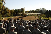 Family members, including those of recently honored aerial fire fighters and more than a thousand airmen of Charlotte's 145th Airlift Wing, North Carolina Air National Guard attend an annual memorial ceremony as a way to remember all airmen who had died in the year prior, whether a current or past member. Following a flyover of three C-130 Hercules, the aircraft used by the wing to accomplish its missions, the names are pronounced of any Air Guard member who has deceased over the last twelve months to a bagpipe rendition of "Amazing Grace," the formation of airmen at attention for a twenty-one gun salute, then a bugler performing "Taps," and the laying of a wreath in honor and remembrance of those who have passed.