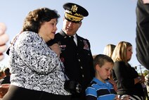 Family members, including those of recently honored aerial fire fighters and more than a thousand airmen of Charlotte's 145th Airlift Wing, North Carolina Air National Guard attend an annual memorial ceremony as a way to remember all airmen who had died in the year prior, whether a current or past member. Following a flyover of three C-130 Hercules, the aircraft used by the wing to accomplish its missions, the names are pronounced of any Air Guard member who has deceased over the last twelve months to a bagpipe rendition of "Amazing Grace," the formation of airmen at attention for a twenty-one gun salute, then a bugler performing "Taps," and the laying of a wreath in honor and remembrance of those who have passed.