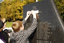 Family members, including those of recently honored aerial fire fighters and more than a thousand airmen of Charlotte's 145th Airlift Wing, North Carolina Air National Guard attend an annual memorial ceremony as a way to remember all airmen who had died in the year prior, whether a current or past member. Following a flyover of three C-130 Hercules, the aircraft used by the wing to accomplish its missions, the names are pronounced of any Air Guard member who has deceased over the last twelve months to a bagpipe rendition of "Amazing Grace," the formation of airmen at attention for a twenty-one gun salute, then a bugler performing "Taps," and the laying of a wreath in honor and remembrance of those who have passed.