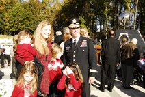 Family members, including those of recently honored aerial fire fighters and more than a thousand airmen of Charlotte's 145th Airlift Wing, North Carolina Air National Guard attend an annual memorial ceremony as a way to remember all airmen who had died in the year prior, whether a current or past member. Following a flyover of three C-130 Hercules, the aircraft used by the wing to accomplish its missions, the names are pronounced of any Air Guard member who has deceased over the last twelve months to a bagpipe rendition of "Amazing Grace," the formation of airmen at attention for a twenty-one gun salute, then a bugler performing "Taps," and the laying of a wreath in honor and remembrance of those who have passed.